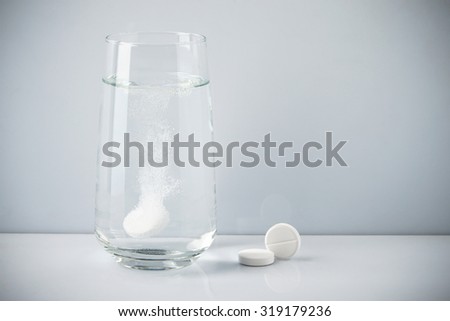 Effervescent tablet dissolved in a glass of water
