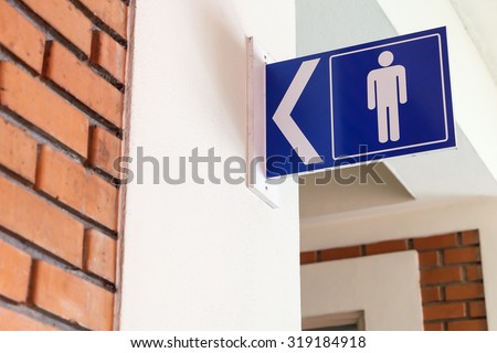 restroom signs with male symbol and arrow direction signs