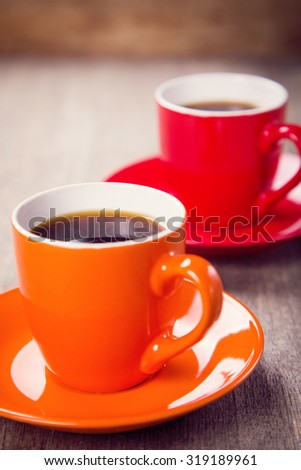 two new cups fool of coffee on wooden background