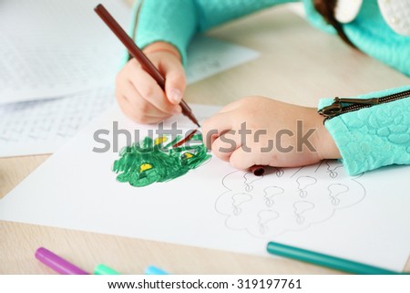 Cute little girl doing her homework, close-up
