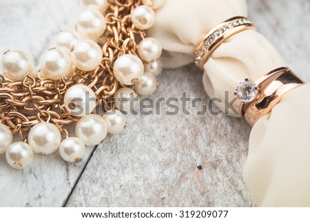 Golden wedding rings on white wood background Royalty-Free Stock Photo #319209077