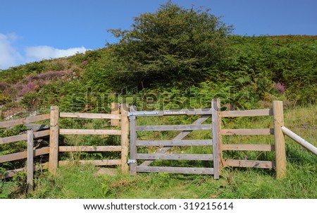 Wooden Gate with "Please Shut Gate" Sign on a Footpath by the River Barle near Simonsbath on Exmoor National Park in Somerset, England, UK