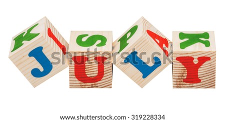 wooden cubes. July word isolated on a white background
