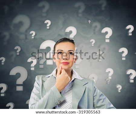 Young pretty businesswoman with question mark over head