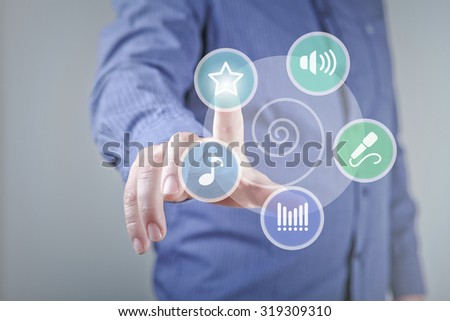 Close up of hand touching music icon with finger