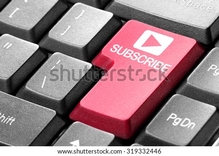Subscribing. gesture of finger pressing subscribe button on a computer keyboard