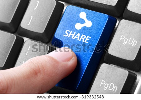 Sharing file. gesture of finger pressing share button on a computer keyboard Royalty-Free Stock Photo #319332548