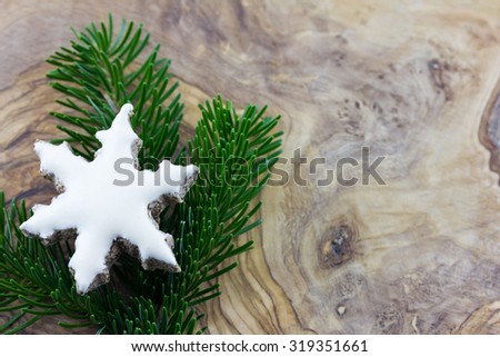 Cinnamon cookies and pine branches on a background of olive wood