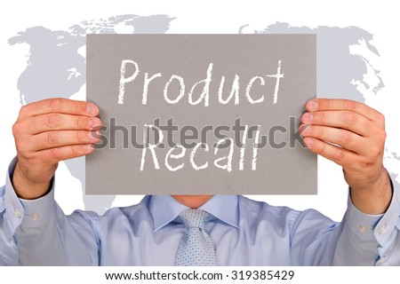 Product Recall - Businessman holding sign with world map in the background