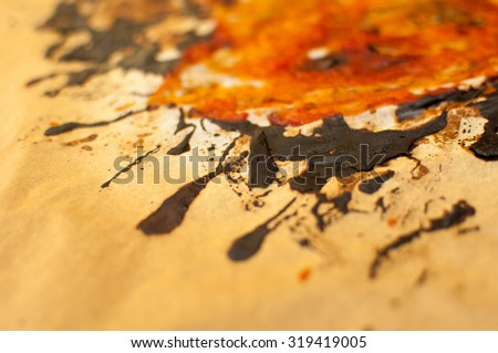 Burned sauce on parchment paper.