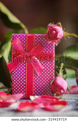  Handmade box with gift  on old pink roses background