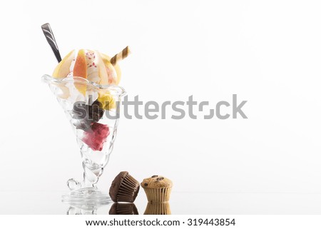 colorful pear sundae decorated with whipping cream on white background