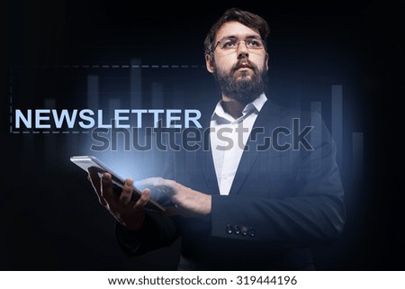 Businessman holding a tablet pc with "Newsletter" text on virtual screen. Business concept.