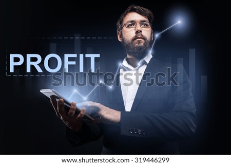 Businessman holding a tablet pc with "Profit" text on virtual screen.