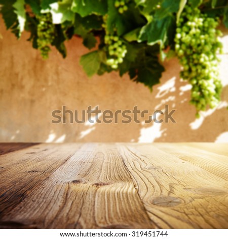 Wine background. Autumn design with vineyard and empty display. Autumn grapes harvest