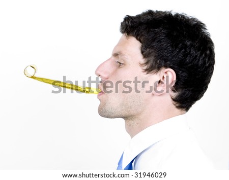 young man blows party blower while wearing shirt