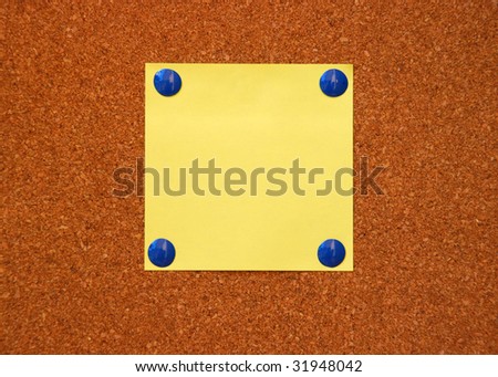 yellow paper on cork board