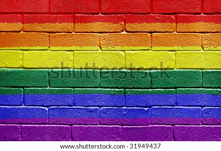 Rainbow flag painted onto a grunge brick wall