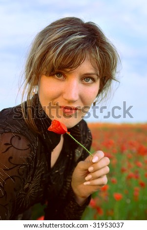 Portrait woman with poppy on nature