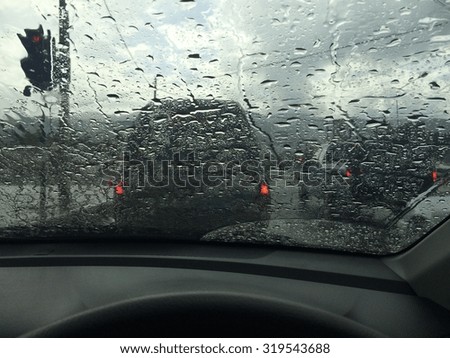 driving car and stuck in heavy rainy day