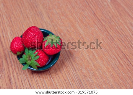 Strawberry on wooden background with copyspace for text