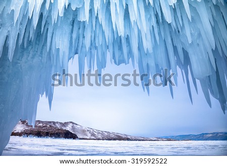 Ice cave near siberian lake Baikal in winter Royalty-Free Stock Photo #319592522