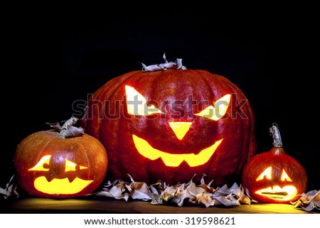 Halloween. Jack O' Lantern on the black with leaves.