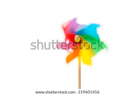 Pinwheel toy with motion blur on white background.