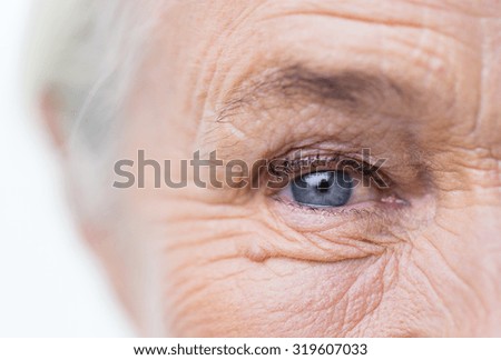 age, vision and old people concept - close up of senior woman face and eye Royalty-Free Stock Photo #319607033
