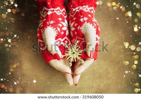 Woman hands holding christmas snowflake