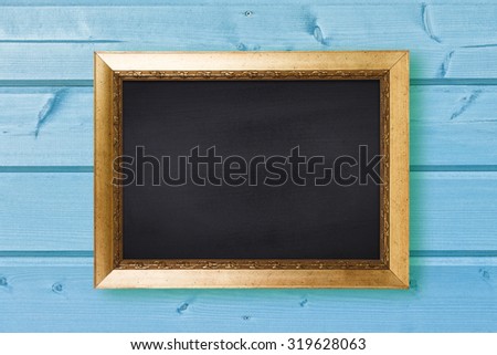 Chalkboard in vintage frame on blue wooden wall texture