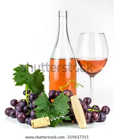 Rose wine bottle, wineglass, grapes, and corkscrew.