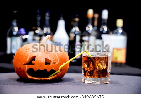 Halloween party. Funny Pumpkin with a cocktail