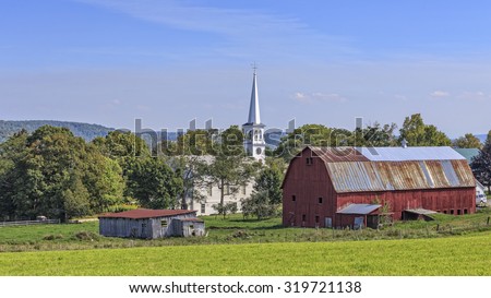 The picture perfect town of Peacham Vermont with its large red barn and white New England church dominating the villiage.