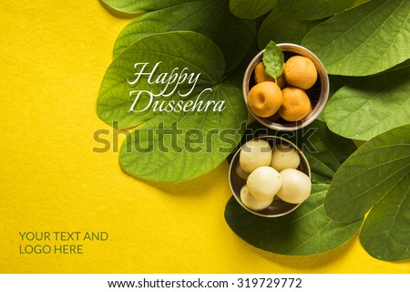 Happy Dussehra greeting card using apta  / Bauhinia racemosa / Bidi leaf and indian sweet pedha or pera Royalty-Free Stock Photo #319729772