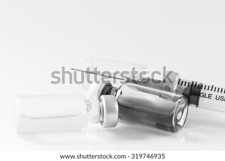 Medical ampoules and syringe on white background in monotone style.Vaccination.