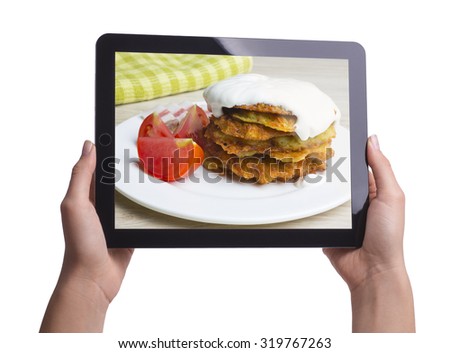 potato pancakes on the screen of the tablet