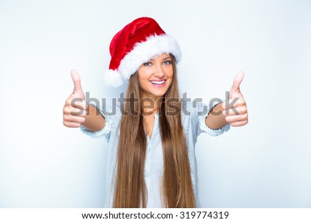 portrait of a smiling beautiful happy girl in christmas santa hat. beauty woman. isolated on white background. happy new year 2016.