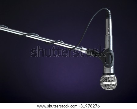 A microphone on a boom over a blue background.