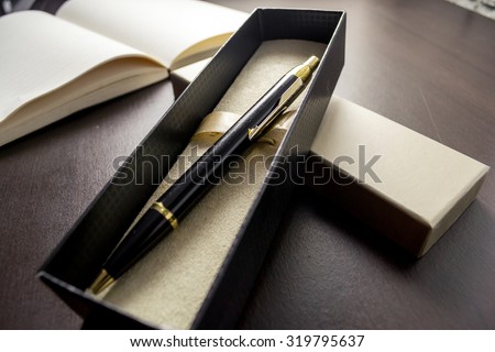 gift pen  in box / selective focus / filter vintage. Royalty-Free Stock Photo #319795637