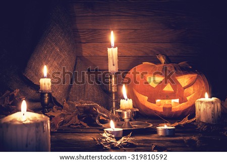 Pumpkin around burning candles