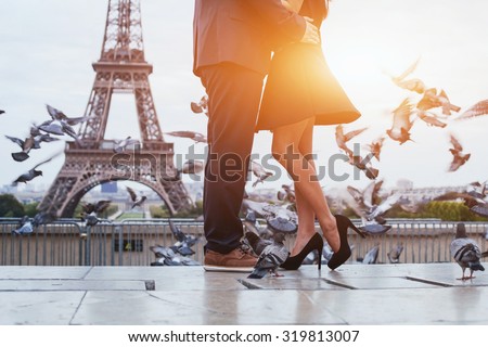 couple near Eiffel tower in Paris, romantic kiss Royalty-Free Stock Photo #319813007