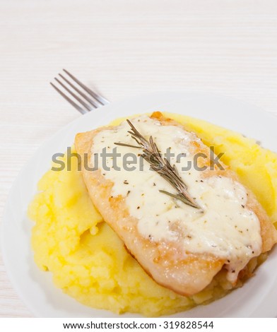 fish fillet under cheese with mashed potatoes