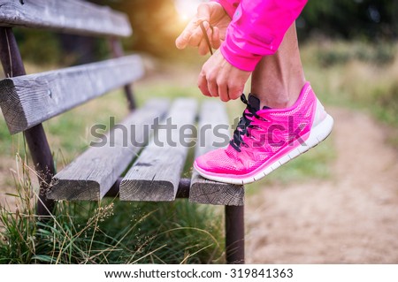 Young sportive woman getting ready to start running workout - Athlete running outdoors at sunset - Attractive girl making sport to lose weight and stay fit Royalty-Free Stock Photo #319841363