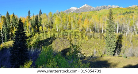 landscape view of the colorful alpine scenery with snow covered mountains during foliage season at Kebler and Ohio Passes