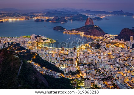 Spectacular aerial view over Rio de Janeiro as viewed from Corcovado. The famous Sugar Loaf peak sticks out of Guanabara Bay Royalty-Free Stock Photo #319863218