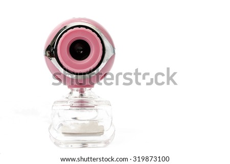 closeup of pink web camera on white background.