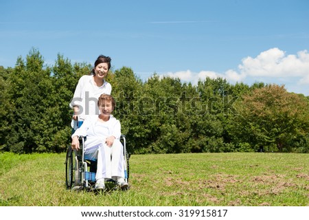 Senior riding in a wheelchair in the park