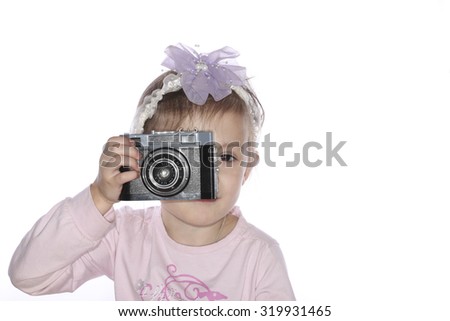 Young girl holding old camera isolated on white background