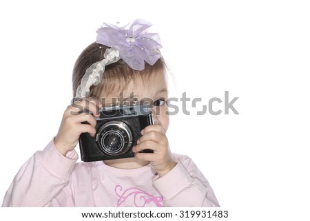 Young girl holding old camera isolated on white background